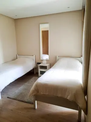 a bedroom with two beds and a mirror at Luxury Apartments in Marrakech