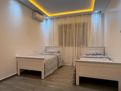 a bedroom with two beds and a window at Moderne spacieux cosy in Marrakech