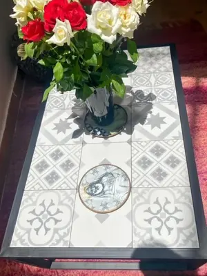 a vase with flowers in it on a table at Riad coup de coeur, Medina, Marrakech in Marrakech