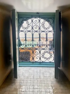 an open door with a gate with a view at Riad coup de coeur, Medina, Marrakech in Marrakech