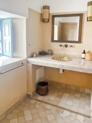 a bathroom with a sink and a mirror at Riad coup de coeur, Medina, Marrakech in Marrakech