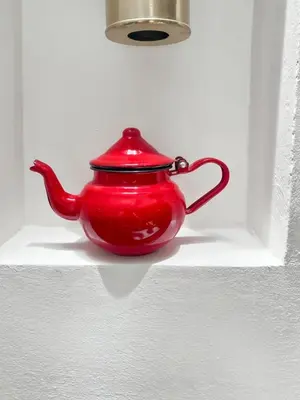 a red tea pot is sitting in a window at Riad coup de coeur, Medina, Marrakech in Marrakech