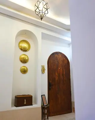 a hallway with a wooden door in a room at Little date in Marrakech