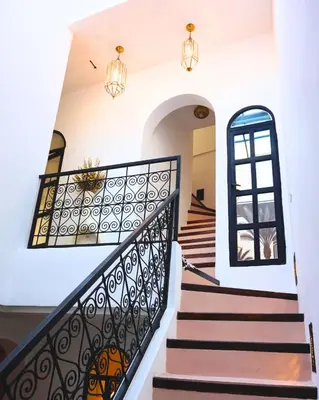 a staircase in a home with a wrought iron railing at Little date in Marrakech