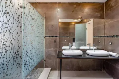 a bathroom with two sinks and a mirror at Golf Resort 4BR Villa Heated Pool Free Pickup in Marrakech