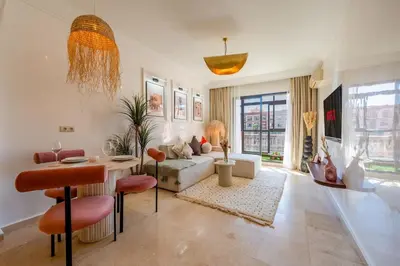 a living room with a couch and a table at Secure Stylish Flat Gueliz Pool WiFi Parking in Marrakech