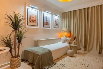 a bedroom with a bed and a potted plant at Secure Stylish Flat Gueliz Pool WiFi Parking in Marrakech