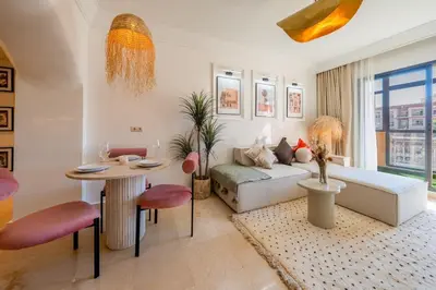 a living room with a couch and a table at Secure Stylish Flat Gueliz Pool WiFi Parking in Marrakech