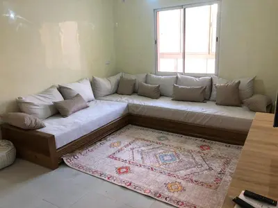 a large white couch in a living room with a window at Majorelle louza in Marrakech