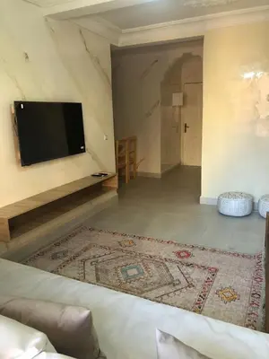 a living room with a flat screen tv on a wall at Majorelle louza in Marrakech