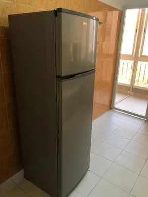 a stainless steel refrigerator in a kitchen with a window at Majorelle louza in Marrakech