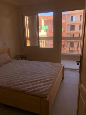 a bedroom with a bed and a large window at Majorelle louza in Marrakech