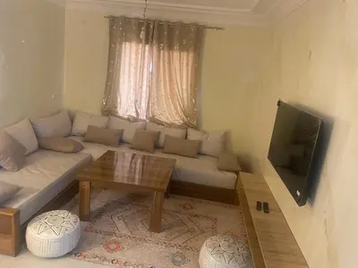 a living room with a couch and a television at Majorelle louza in Marrakech
