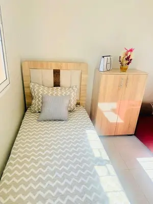 a bedroom with a bed and a wooden cabinet at TheCosyCorner in Marrakech