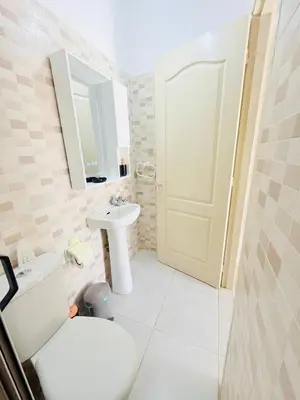 a bathroom with a white toilet and a sink at TheCosyCorner in Marrakech