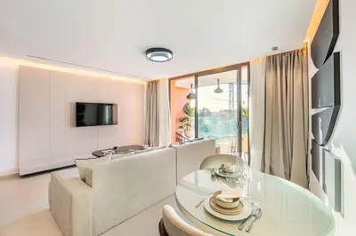a living room with a table and a couch at New apartment, quiet and well located with balcony in Marrakech