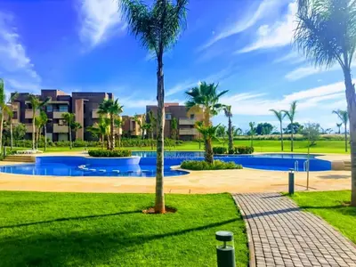 a resort with a swimming pool and palm trees at Elegant Studio-Prestigia Agate in Marrakech