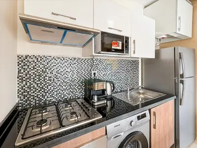 a small kitchen with a stove and a microwave at Elegant Studio-Prestigia Agate in Marrakech