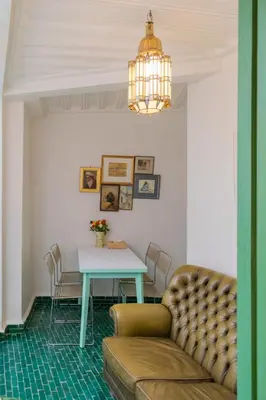 a living room with a table and a couch at Riad Dar 77 in der Medina mit Terrasse in Marrakech