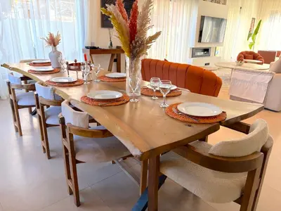 a wooden table with chairs and a dining room at Palais Naya in Marrakech