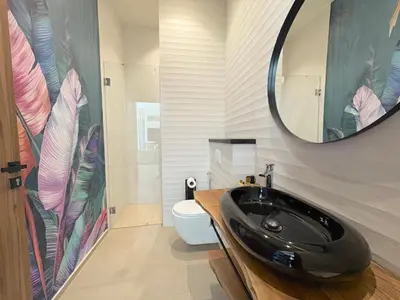 a bathroom with a black sink and a mirror at Palais Naya in Marrakech