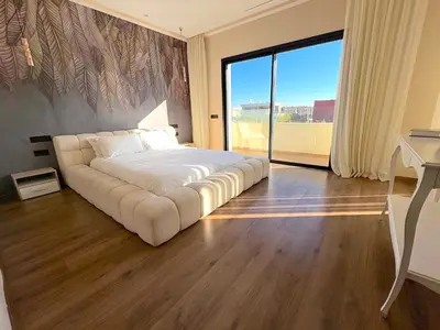 a large white bed in a room with a large window at Palais Naya in Marrakech