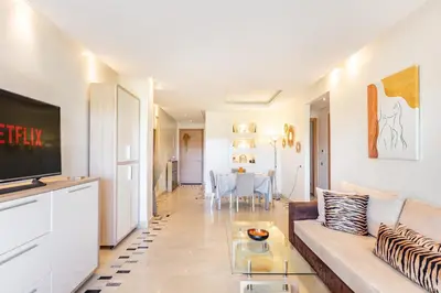 a living room with a couch and a table at Golf View Escape in Oulad Akkou