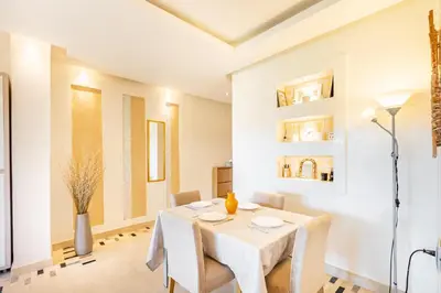 a dining room with a white table and chairs at Golf View Escape in Oulad Akkou