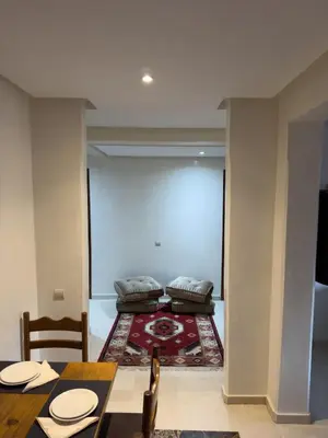 a dining room with a table and a couch at Luxury 2 bedroom apartment - Gueliz Plaza in Marrakech