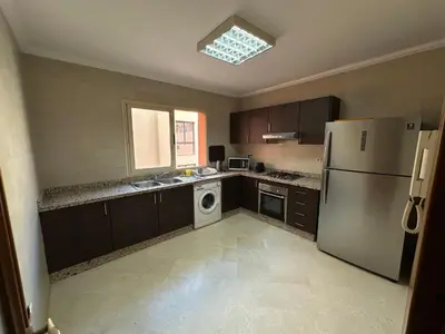 a kitchen with a refrigerator and a washing machine at Luxury 2 bedroom apartment - Gueliz Plaza in Marrakech