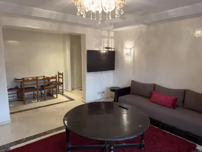 a living room with a couch and a table at Luxury 2 bedroom apartment - Gueliz Plaza in Marrakech