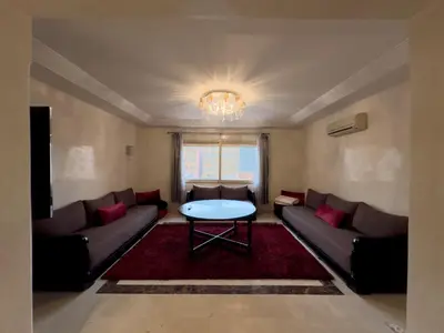a living room with a couch and a table at Luxury 2 bedroom apartment - Gueliz Plaza in Marrakech