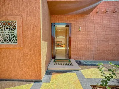 a hallway of a house with a brick wall at Villa Andalus - Piscine privée & Suite Parentale in Marrakech