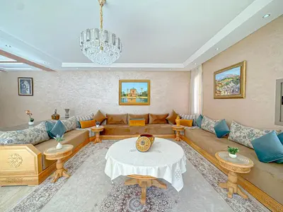a living room with a couch and a table at Villa Andalus - Piscine privée & Suite Parentale in Marrakech