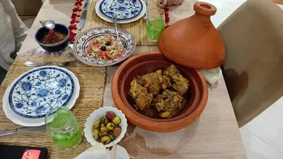 a table with a bowl of food and plates of food at Chambre dans un Maison traditionnel avec jardin système de riad dans une ambiance familiale marocain in Marrakech