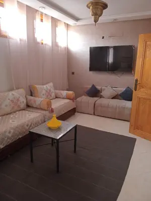 a living room with a couch and a table at Chambre dans un Maison traditionnel avec jardin système de riad dans une ambiance familiale marocain in Marrakech