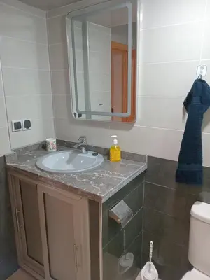 a bathroom with a sink and a mirror at Chambre dans un Maison traditionnel avec jardin système de riad dans une ambiance familiale marocain in Marrakech