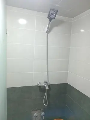a shower with a shower head in a bathroom at Chambre dans un Maison traditionnel avec jardin système de riad dans une ambiance familiale marocain in Marrakech