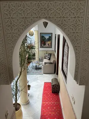 an archway in a living room with a red carpet at Riad Marhaba Kasbah in Marrakech