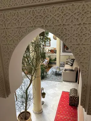 an archway in a living room with a potted tree at Riad Marhaba Kasbah in Marrakech