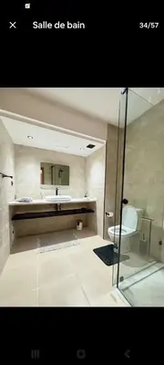 a bathroom with a sink and a toilet and a mirror at Appart cosy & chic premium Village, 5 piscines in Marrakech