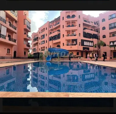 a large swimming pool in front of some buildings at Appart cosy & chic premium Village, 5 piscines in Marrakech
