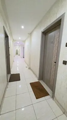 a hallway with two doors and a tile floor at Cocon Zen in Marrakech