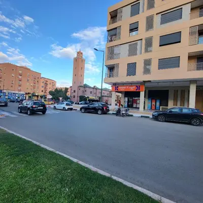 a city street with cars parked in front of a building at Cocon Zen in Marrakech