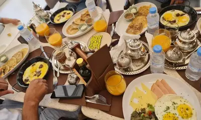 a table topped with plates of breakfast food and orange juice at Cocon Zen in Marrakech