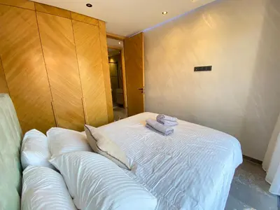 a bed with two towels sitting on top of it at Chic garden & grand balcon in Marrakech