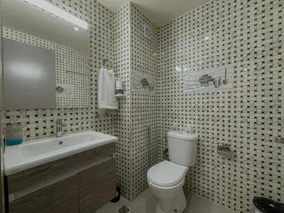 a bathroom with a white toilet and a sink at Essalmi Duplex Apartment in Marrakech in Marrakech