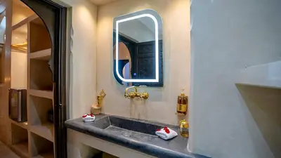 a bathroom with a sink and a mirror at Riad Le Soleil Rouge in Marrakech