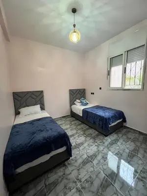 a bedroom with two beds and a ceiling at Appartement Moderne a Marrakech - 2 Chambres, Salon et Cuisine Equipee in Marrakech