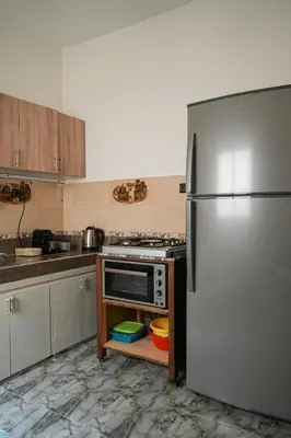 a kitchen with a stainless steel refrigerator at Appartement Moderne a Marrakech - 2 Chambres, Salon et Cuisine Equipee in Marrakech